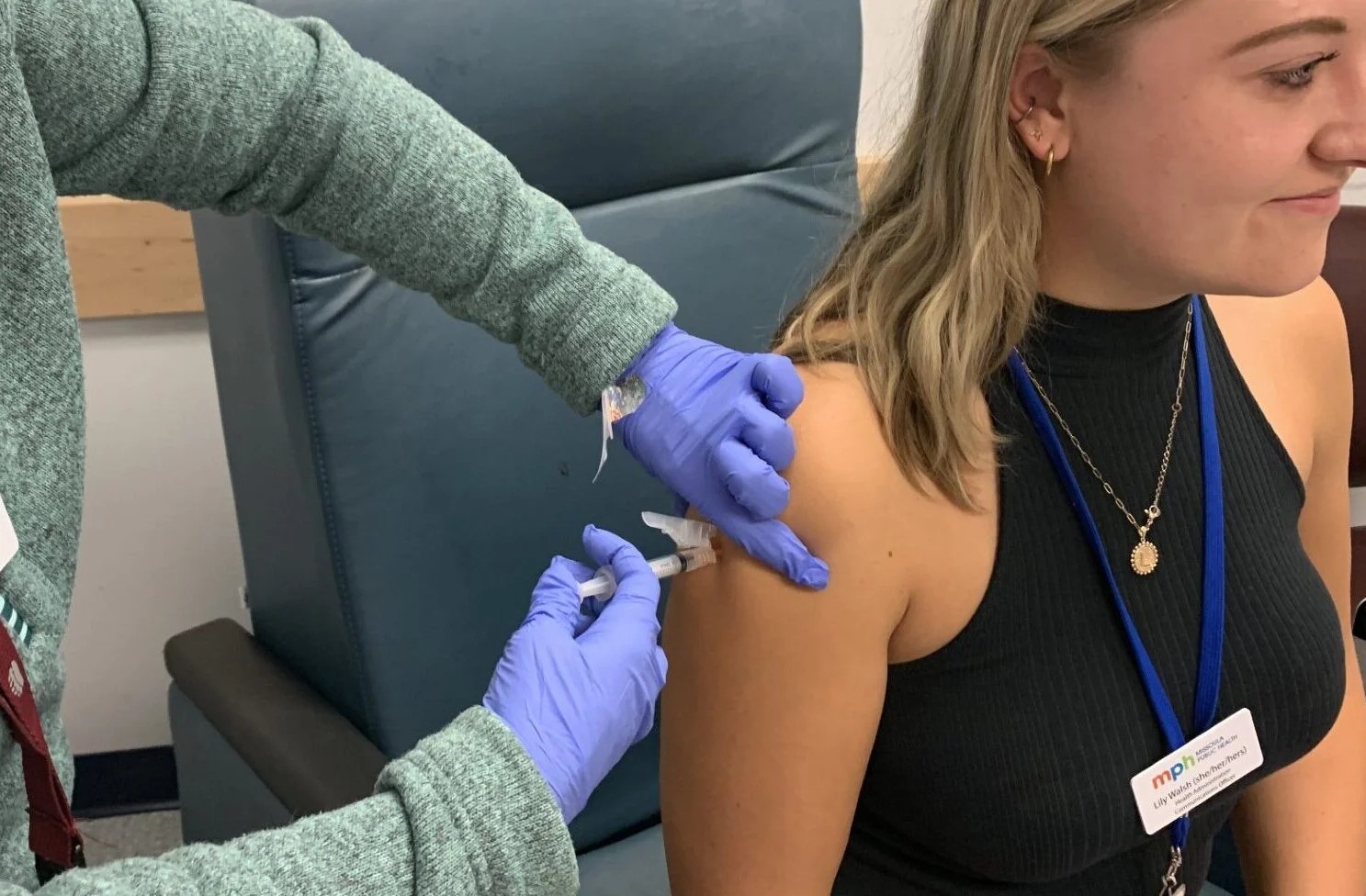 Woman getting immunization shot in a medical clinic