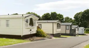 Five mobile homes in a mobile home park on a sunny day